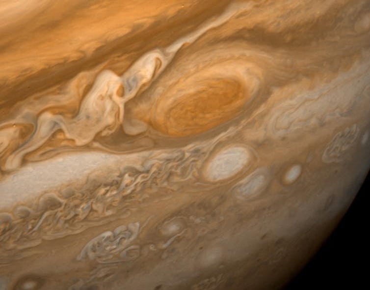 An image of Jupiter featuring brown, beige and orange belts along with the Great Red Spot.